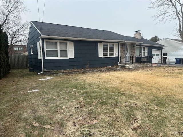 view of front facade with a front yard, a chimney, a garage, and fence