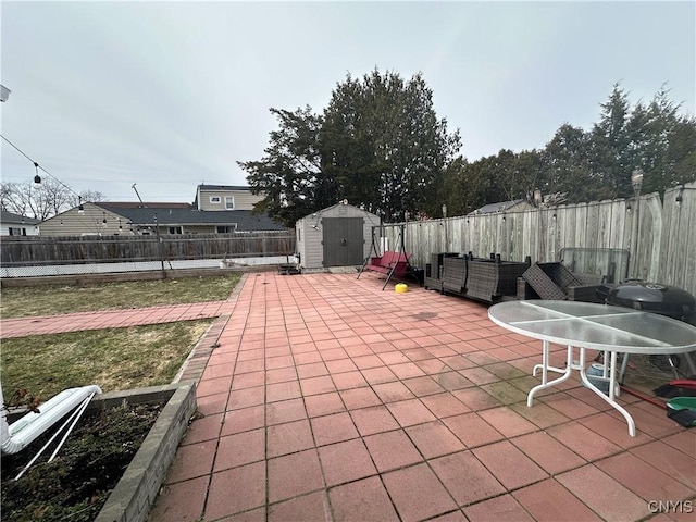 view of patio with a storage shed, a fenced backyard, and an outdoor structure