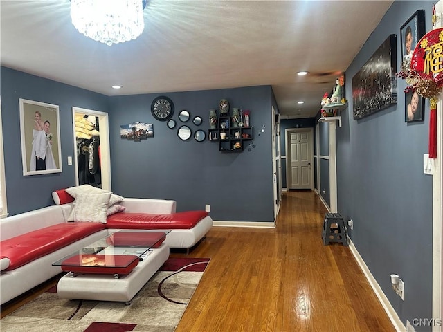 living room with recessed lighting, baseboards, and wood finished floors