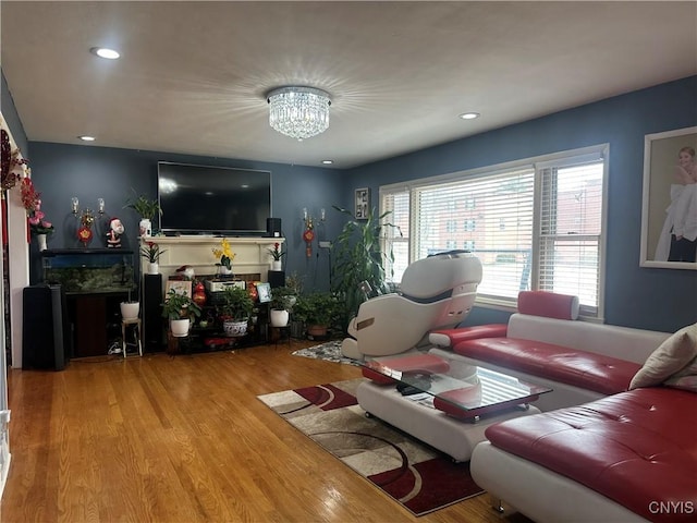 living area with a notable chandelier, wood finished floors, and recessed lighting