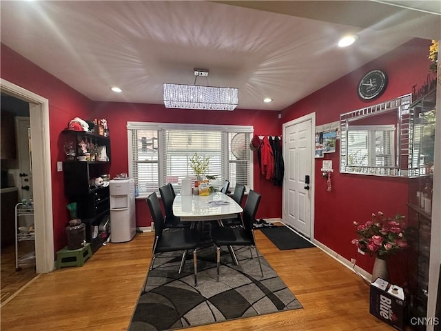 dining area featuring recessed lighting, light wood-type flooring, baseboards, and a notable chandelier