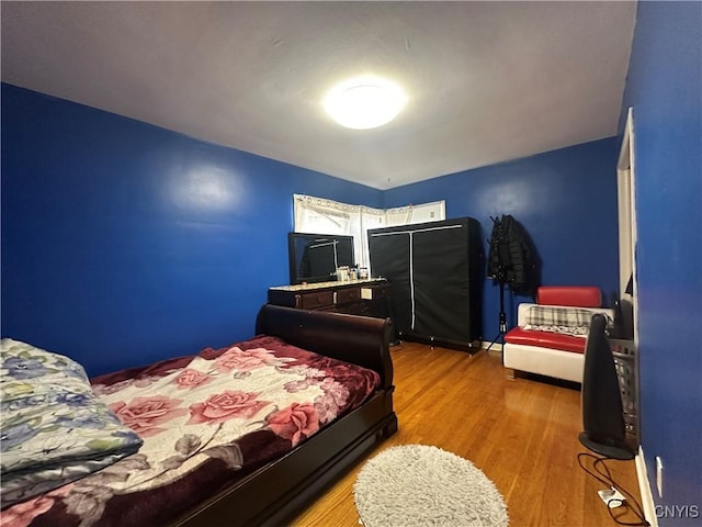 bedroom featuring wood finished floors