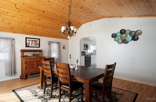 dining area with wooden ceiling, wood finished floors, arched walkways, and vaulted ceiling