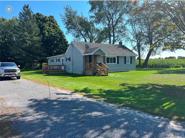 view of front of property featuring a front lawn, driveway, and a chimney