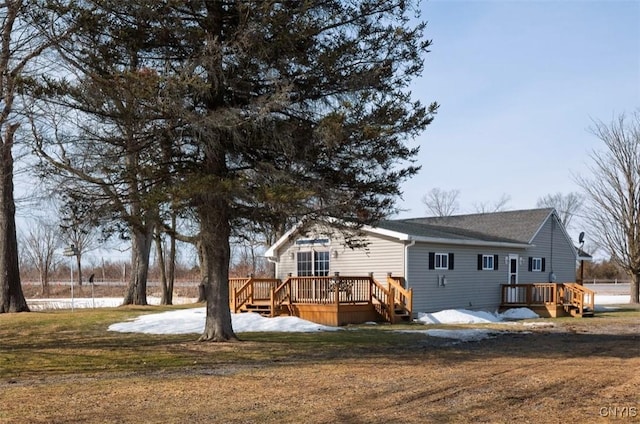 back of house with a lawn and a deck