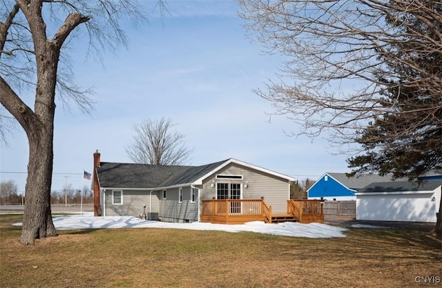 back of house featuring a patio, fence, a yard, a wooden deck, and a chimney