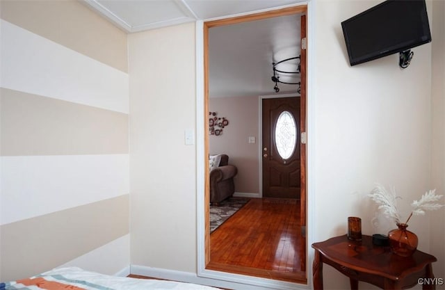 entryway with baseboards and wood finished floors