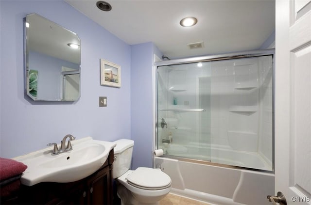 bathroom featuring combined bath / shower with glass door, visible vents, toilet, and vanity