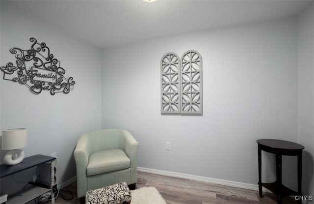 living area with wood finished floors and baseboards