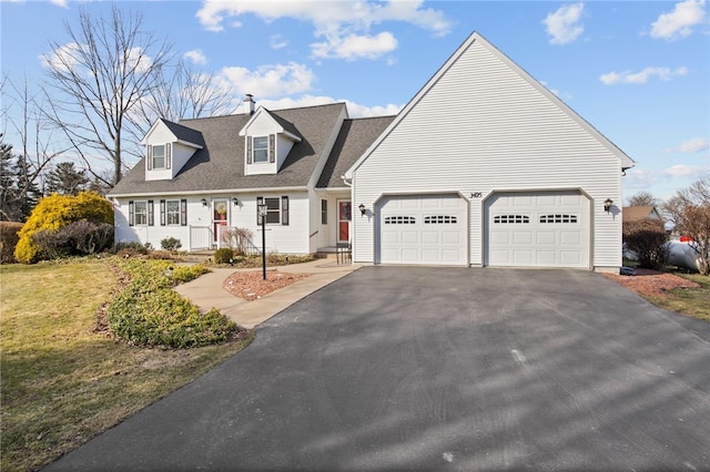 cape cod home with aphalt driveway, a front yard, an attached garage, and a shingled roof