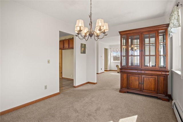 empty room featuring a baseboard heating unit, a notable chandelier, baseboards, and light carpet