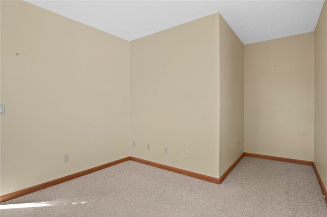 empty room with baseboards and carpet floors