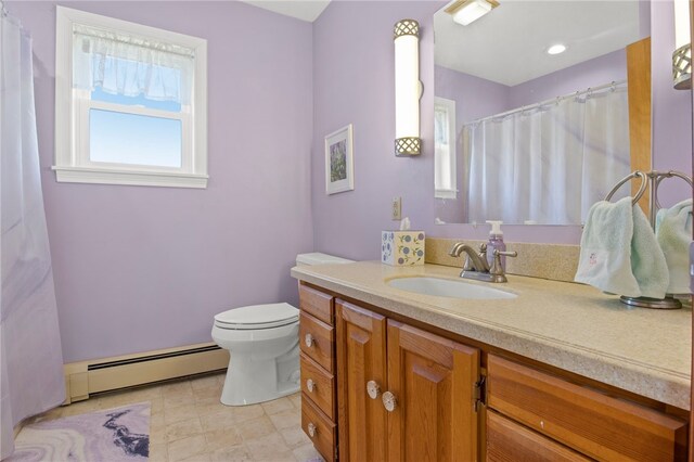 bathroom with baseboard heating, vanity, and toilet