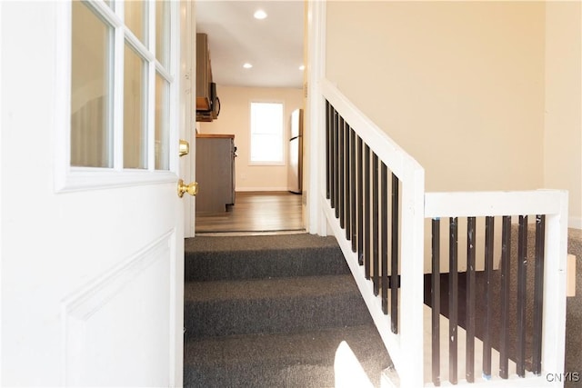 stairway with recessed lighting and baseboards