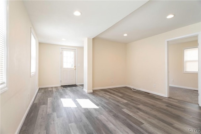 empty room with recessed lighting, baseboards, and wood finished floors