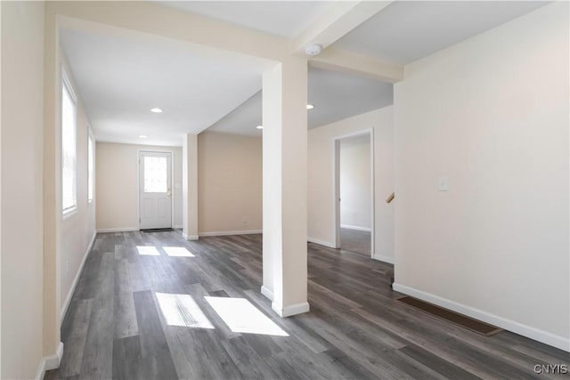 foyer entrance with dark wood-type flooring, recessed lighting, and baseboards