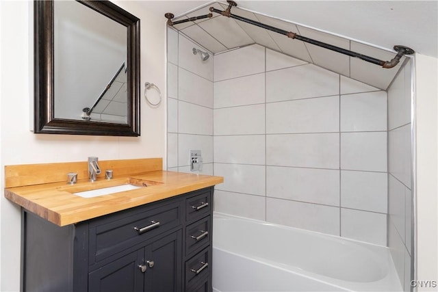 bathroom featuring washtub / shower combination and vanity