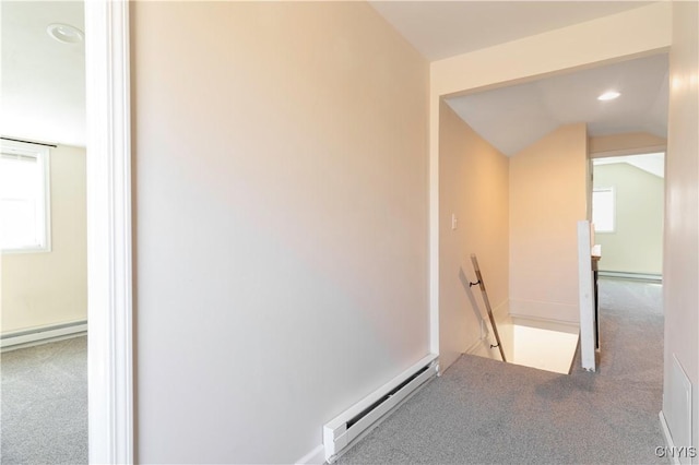 interior space featuring plenty of natural light, a baseboard heating unit, and carpet