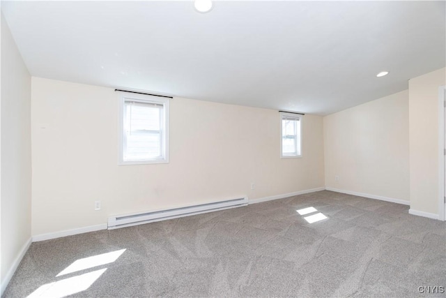 spare room with a baseboard heating unit, recessed lighting, baseboards, and carpet floors