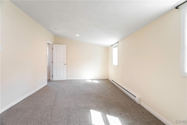 carpeted spare room featuring baseboards and baseboard heating