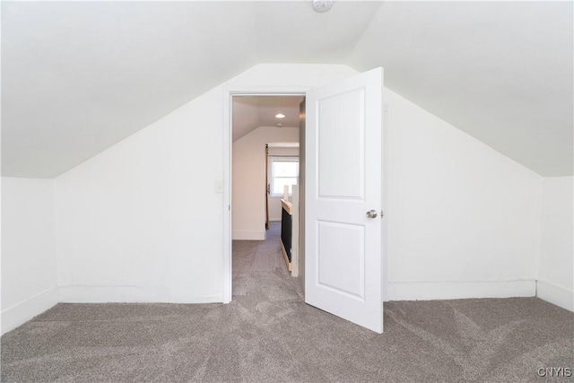 bonus room featuring lofted ceiling and carpet flooring