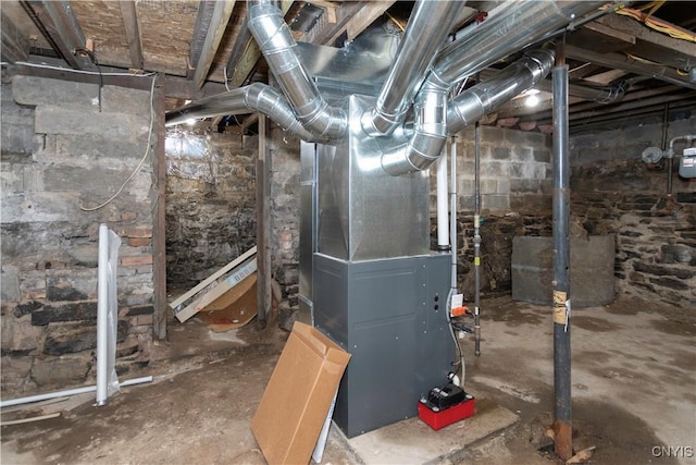 utility room featuring heating unit