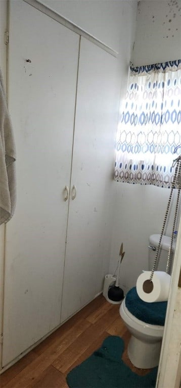 bathroom featuring toilet and wood finished floors