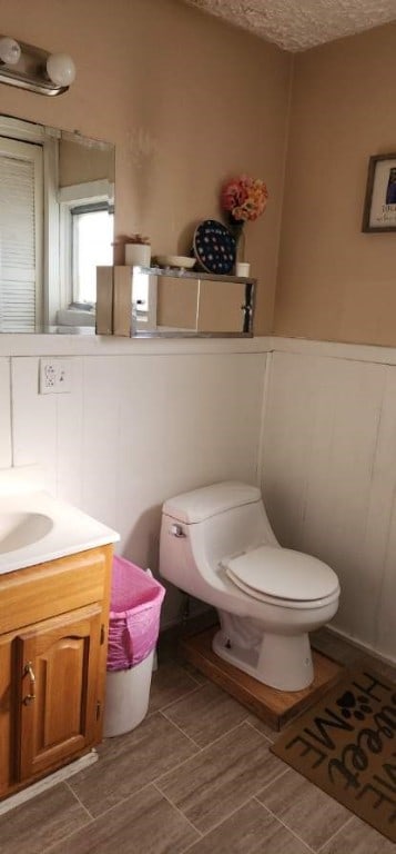 bathroom featuring toilet and vanity