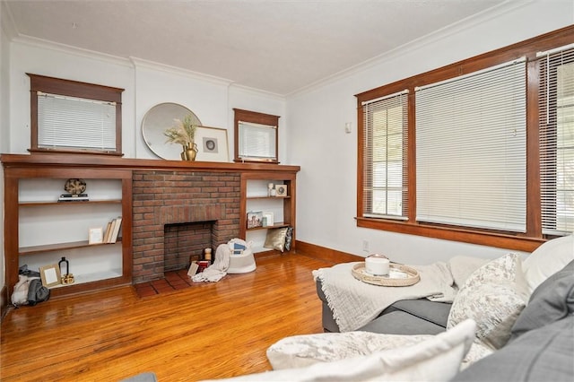 living room with a fireplace, wood finished floors, baseboards, and ornamental molding