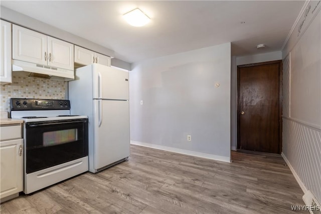 kitchen featuring range with electric cooktop, under cabinet range hood, light wood-style flooring, freestanding refrigerator, and white cabinetry