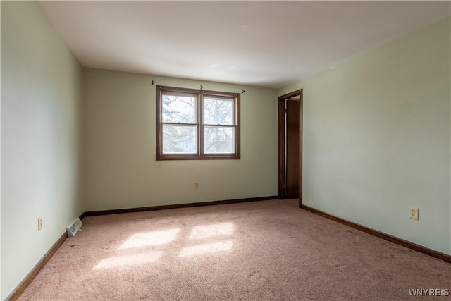 empty room with visible vents, baseboards, and carpet floors