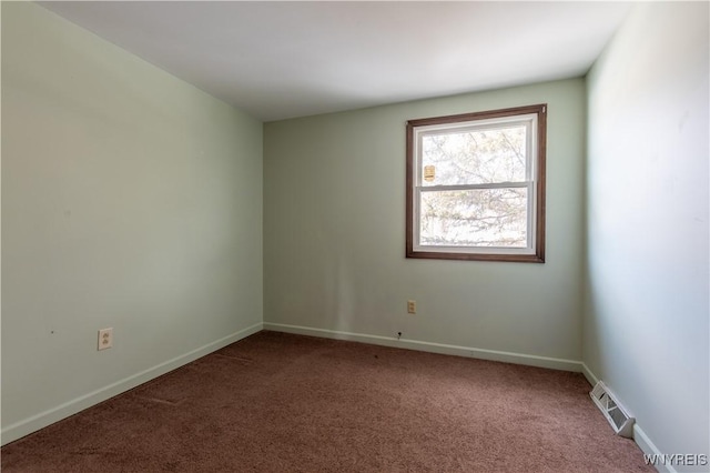 unfurnished room featuring visible vents, baseboards, and carpet flooring