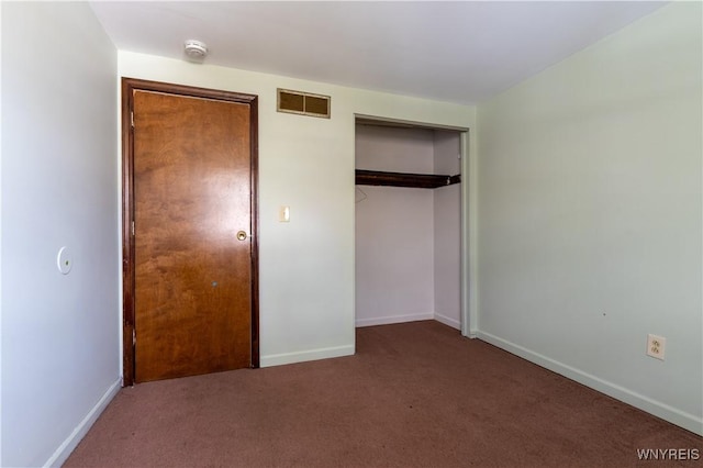 unfurnished bedroom with a closet, visible vents, baseboards, and carpet floors