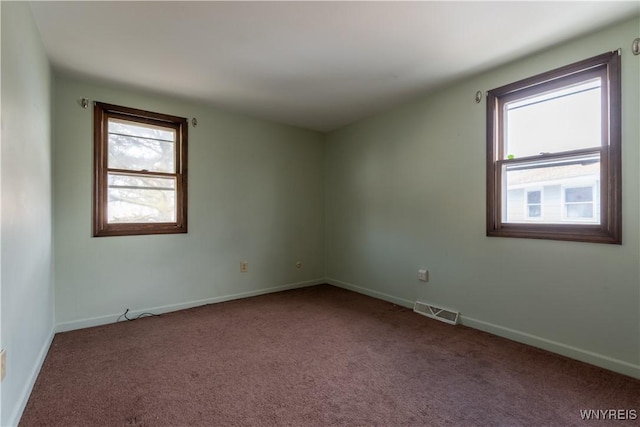 carpeted spare room with baseboards and visible vents