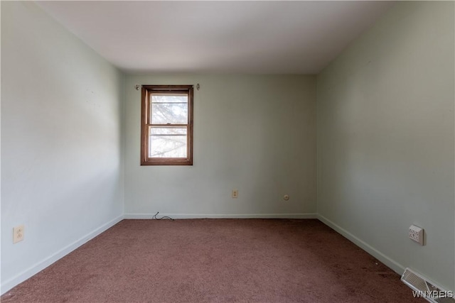 spare room with baseboards, visible vents, and carpet floors