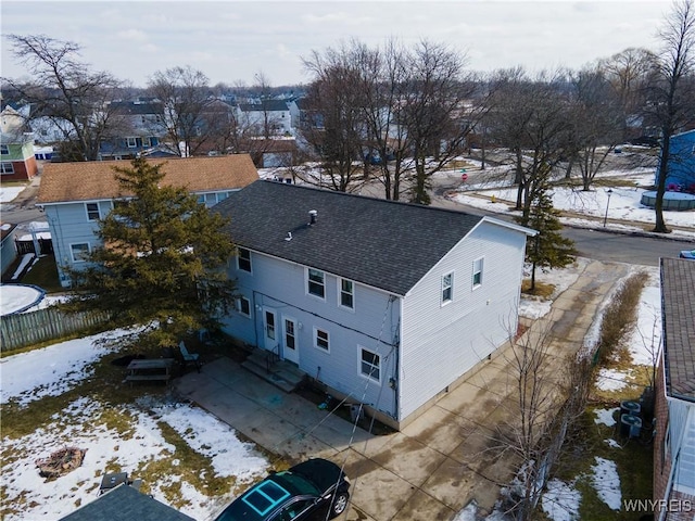 snowy aerial view featuring a residential view