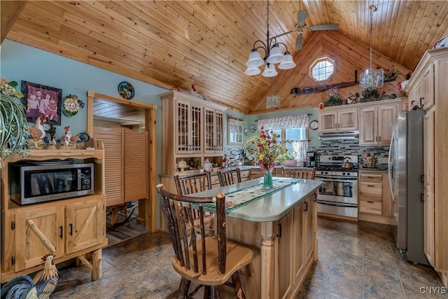 kitchen featuring a center island, under cabinet range hood, wood ceiling, an inviting chandelier, and stainless steel appliances