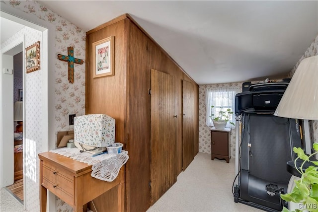 interior space with light colored carpet and wallpapered walls