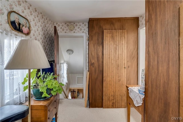 hallway with wallpapered walls and carpet