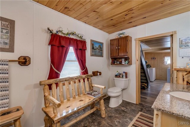 bathroom with vanity, toilet, and wood ceiling