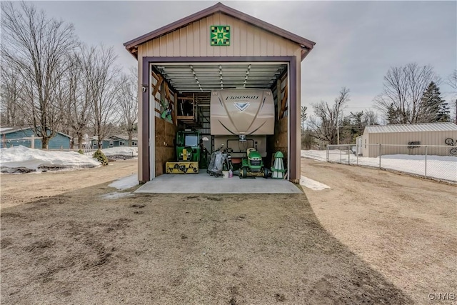 view of outbuilding featuring an outbuilding and fence