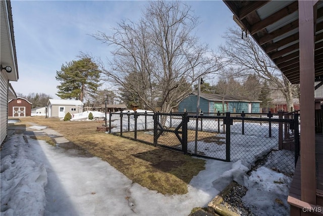 view of yard featuring an outbuilding, a gate, and fence