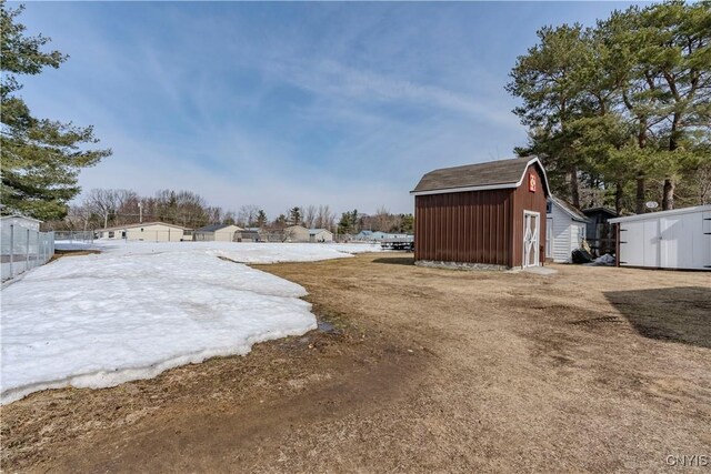 view of yard with a storage shed, fence, and an outdoor structure