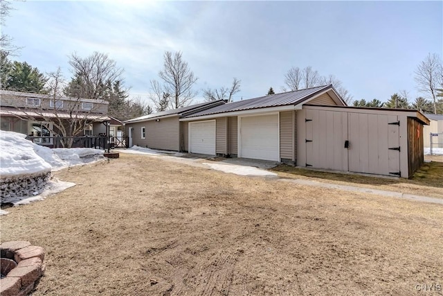 view of side of property with metal roof and an outdoor structure