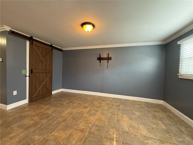 unfurnished room featuring a barn door, baseboards, and ornamental molding