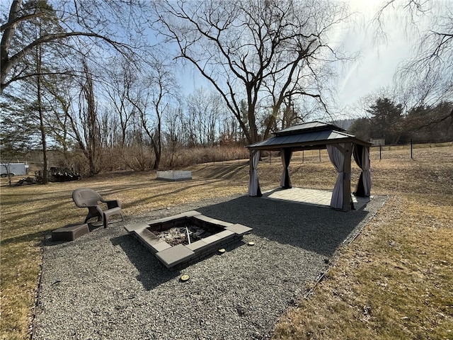 view of yard with a gazebo and an outdoor fire pit