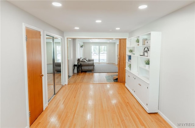 hallway with recessed lighting and light wood-style flooring