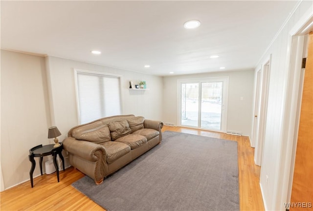 living room featuring light wood-style flooring, recessed lighting, and visible vents