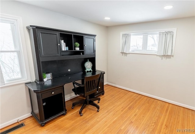 office featuring visible vents, recessed lighting, baseboards, and light wood-style floors