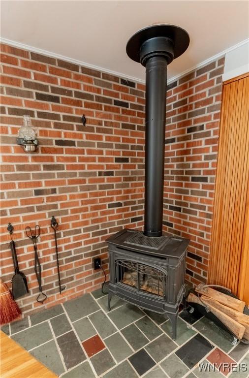 interior details with a wood stove and crown molding